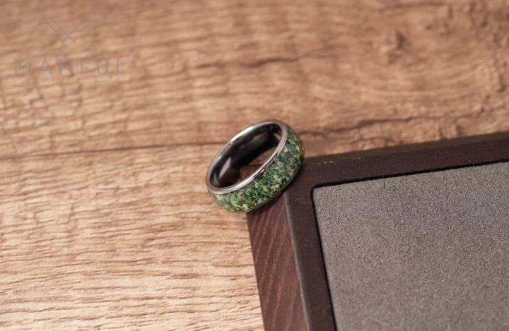 Moss Agate & Crushed Opal Ring, leaning against a dark wood box corner on a wood surface