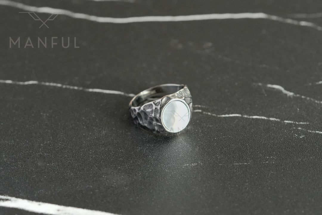 Mother of Pearl Signet Ring, lying flat on dark marble at an angle