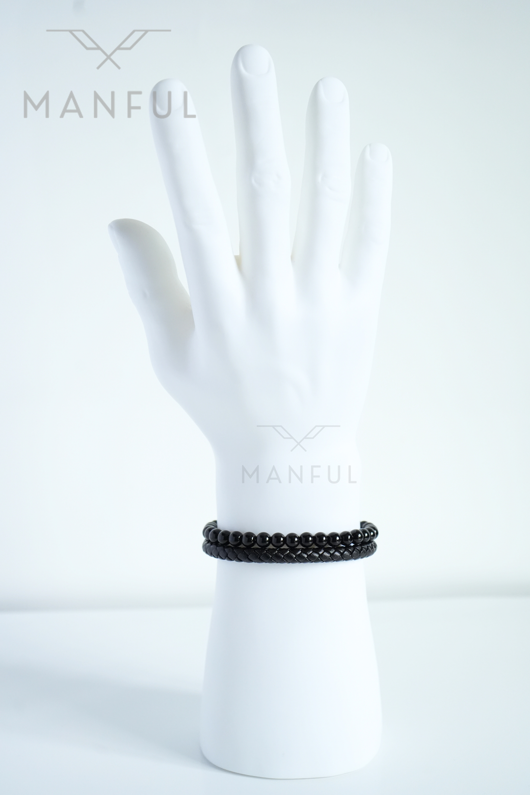 Onyx Bead And Leather Bracelet, worn loose on a mannequin wrist with the clasp turned to the side