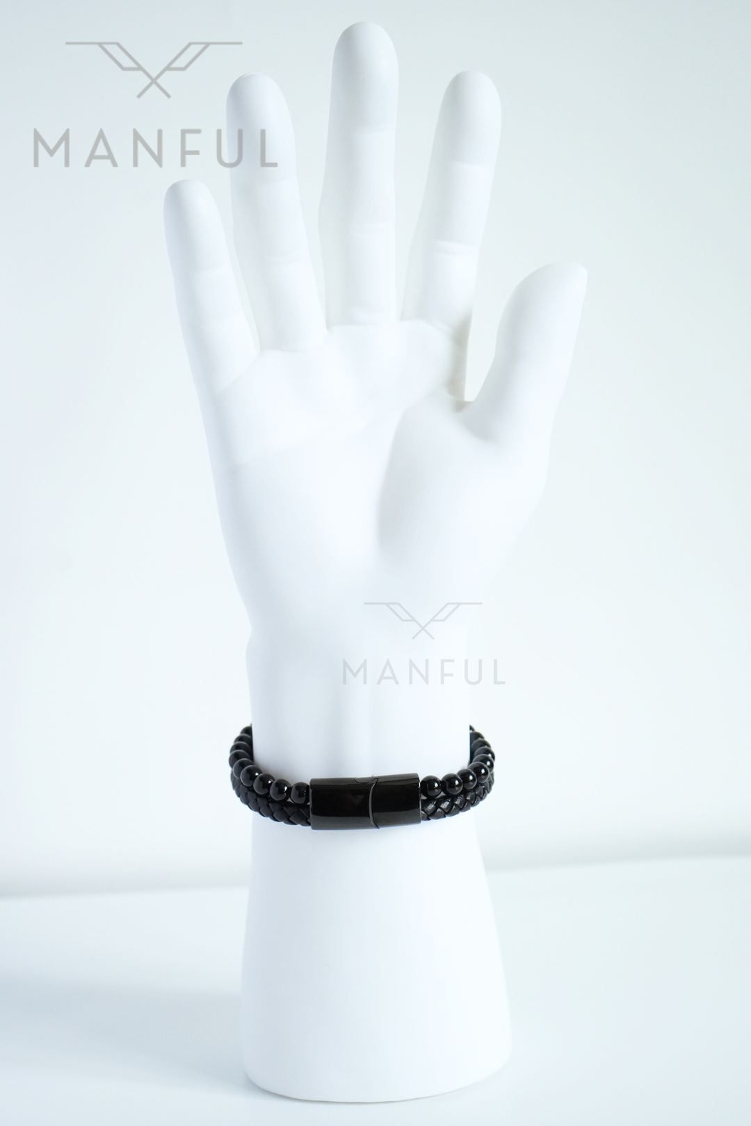 Onyx Bead And Leather Bracelet, worn on a mannequin wrist with the clasp facing the camera