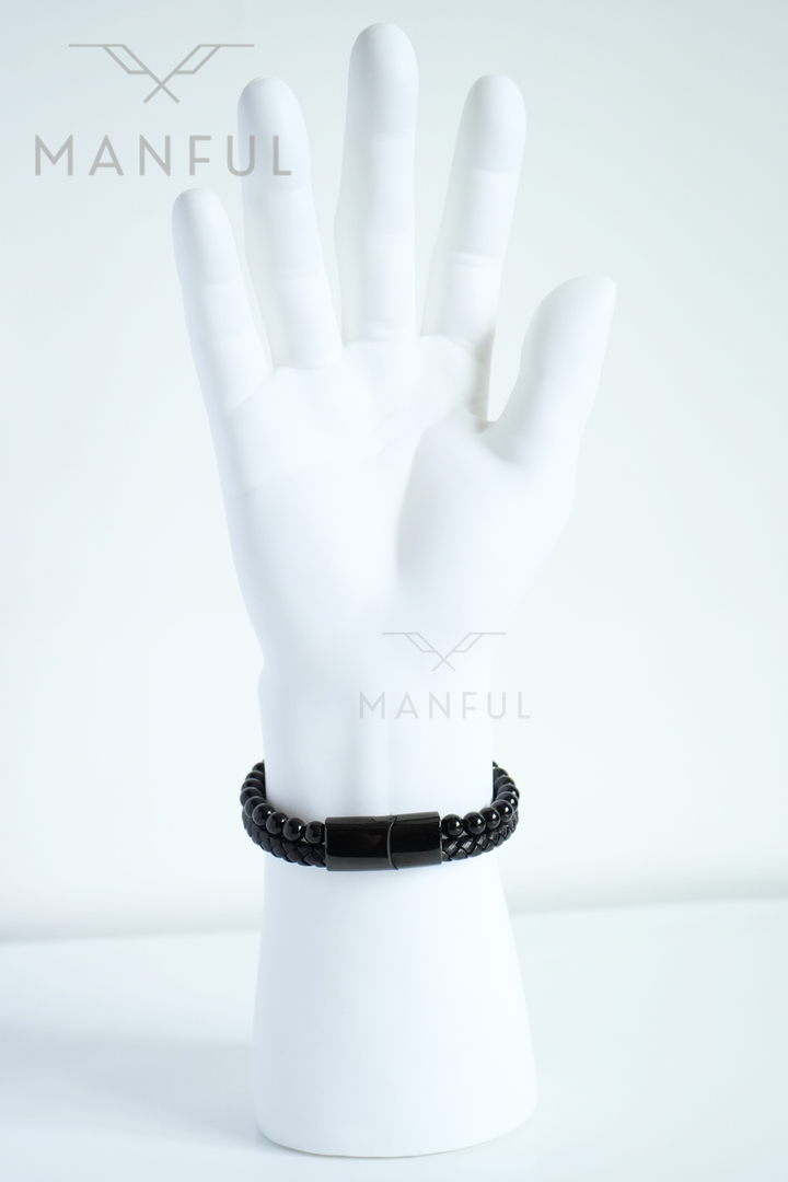 Onyx Bead And Leather Bracelet, worn on a mannequin wrist with the clasp facing the camera