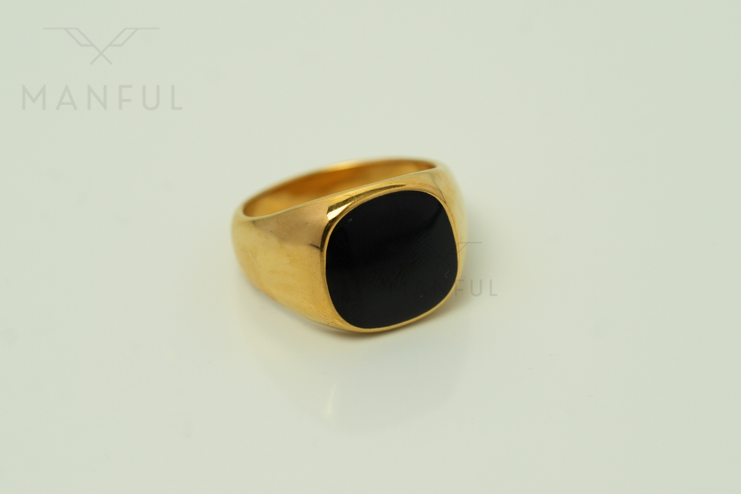 Onyx Signet Ring Gold, angled view on a light background with reflection