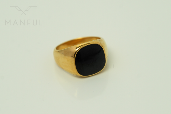 Onyx Signet Ring Gold, angled view on a light background with reflection