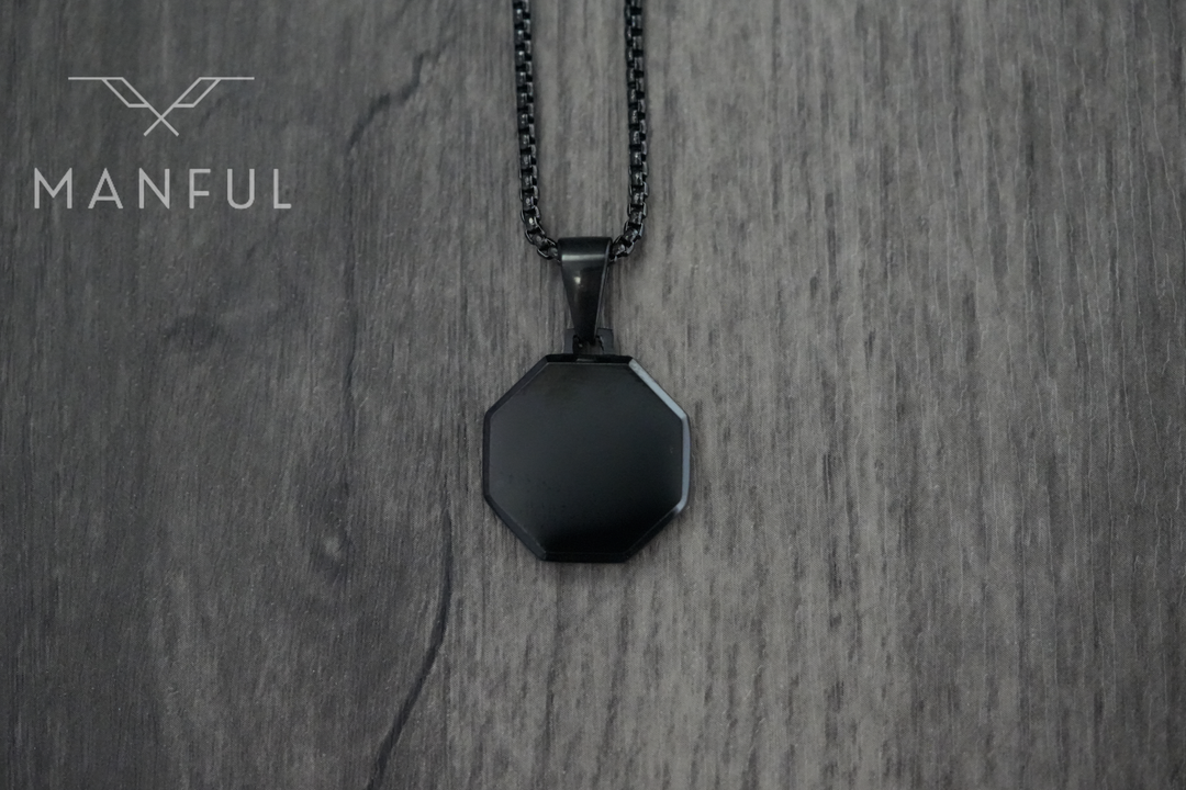 Onyx Octagon Necklace Black, flat lay on a darker woodgrain surface
