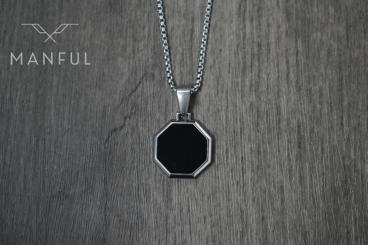 Onyx Octagon Necklace Silver, flat lay on a wood surface showing the front face