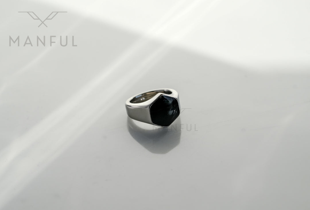 Onyx Silver Hexagon Signet Ring, standing on a plain white background with soft shadow lines
