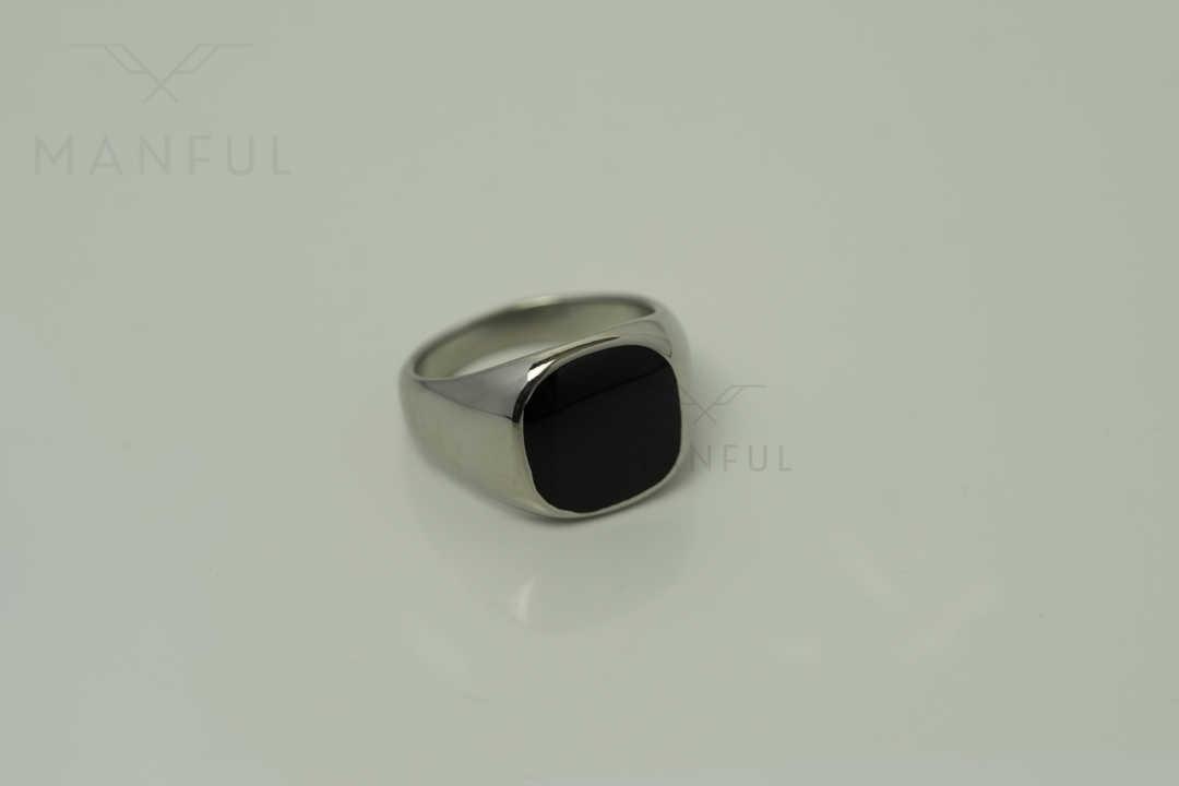 Onyx Signet Ring Silver, angled close up on a plain pale background