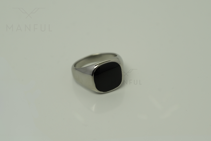 Onyx Signet Ring Silver, angled close up on a plain pale background