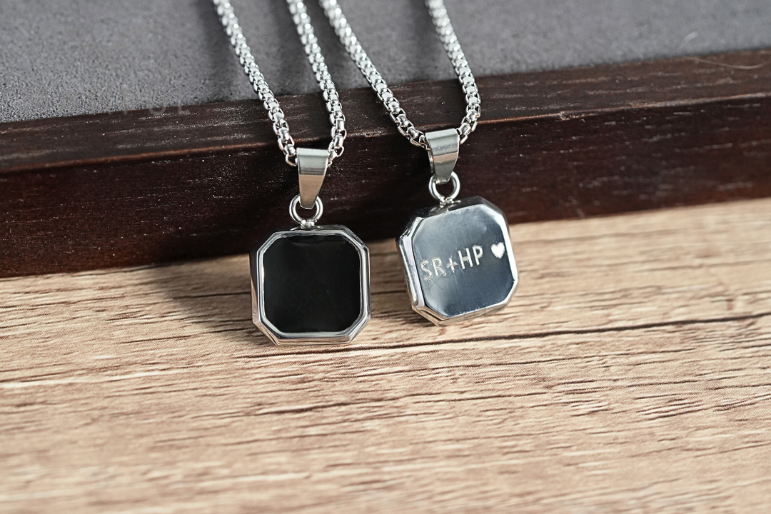 Onyx Square Necklace Silver, shown beside a second pendant engraved SR + HP on the back