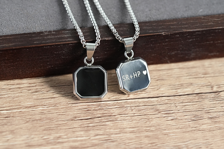 Onyx Square Necklace Silver, shown beside a second pendant engraved SR + HP on the back