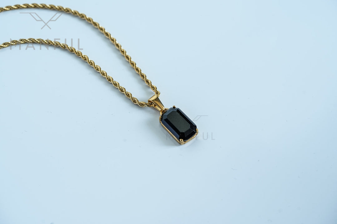 Onyx Stone Pendant Gold, resting on a plain white background with the chain draped to the side