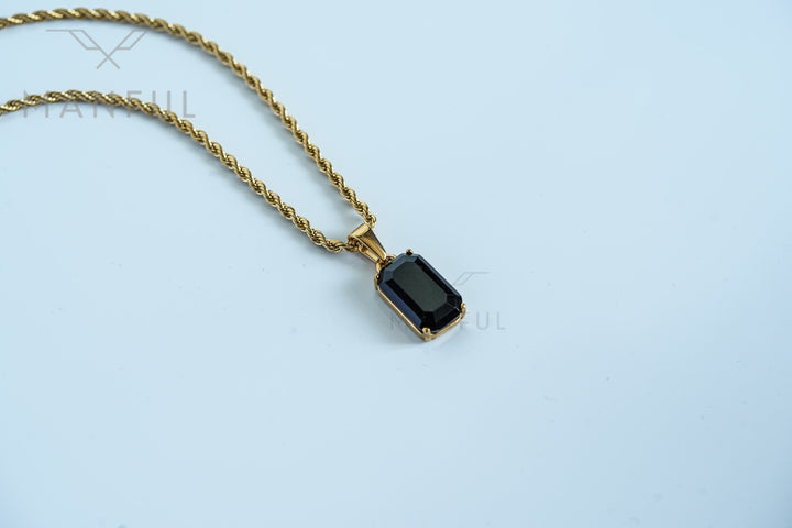 Onyx Stone Pendant Gold, resting on a plain white background with the chain draped to the side
