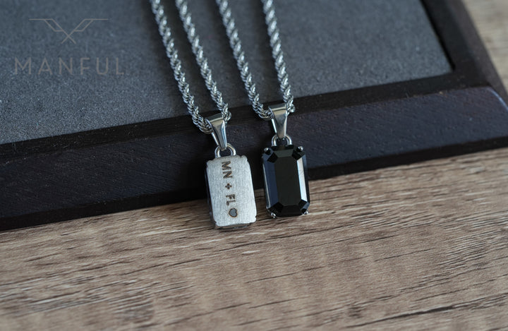 Onyx Stone Pendant Silver, shown beside a second pendant engraved MN + FL on the back