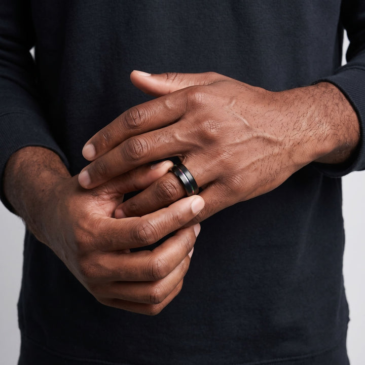 Rainbow Band on a man's finger as he turns it with his other hand