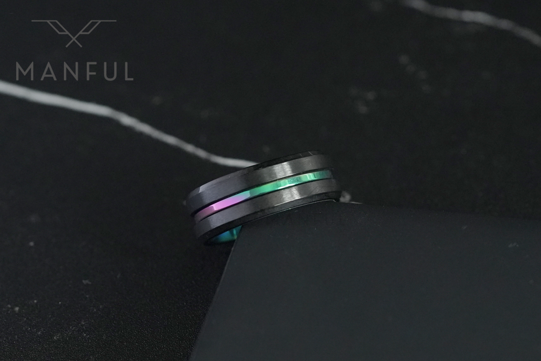 Rainbow Band, propped against the corner of a dark card on marble