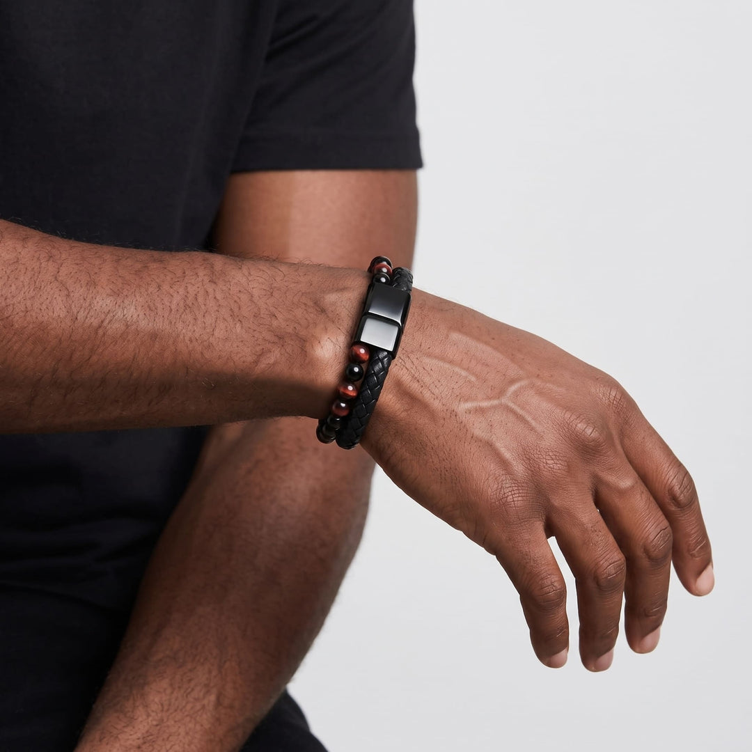 Red Tigers Eye Bead And Leather Bracelet on a man's wrist, his forearm raised with the clasp turned up