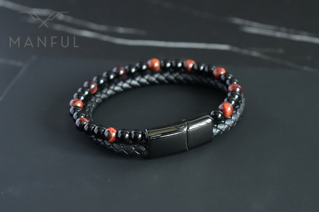 Red Tigers Eye Bead And Leather Bracelet, viewed from above on a dark surface showing the full loop