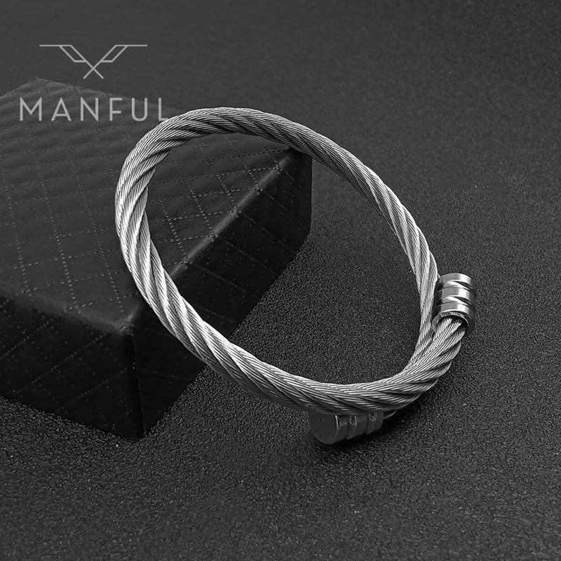 Adjustable Silver Rope Bangle, leaning against a black quilted box on a dark surface