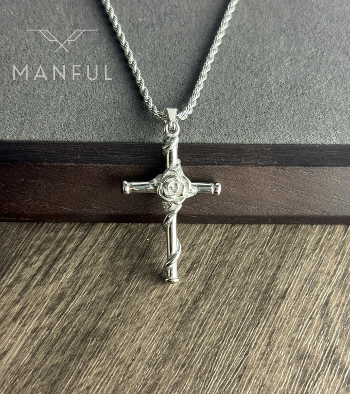 Rose Cross Pendant Necklace Silver, hanging against a dark wood background in a close-up of the rose detail