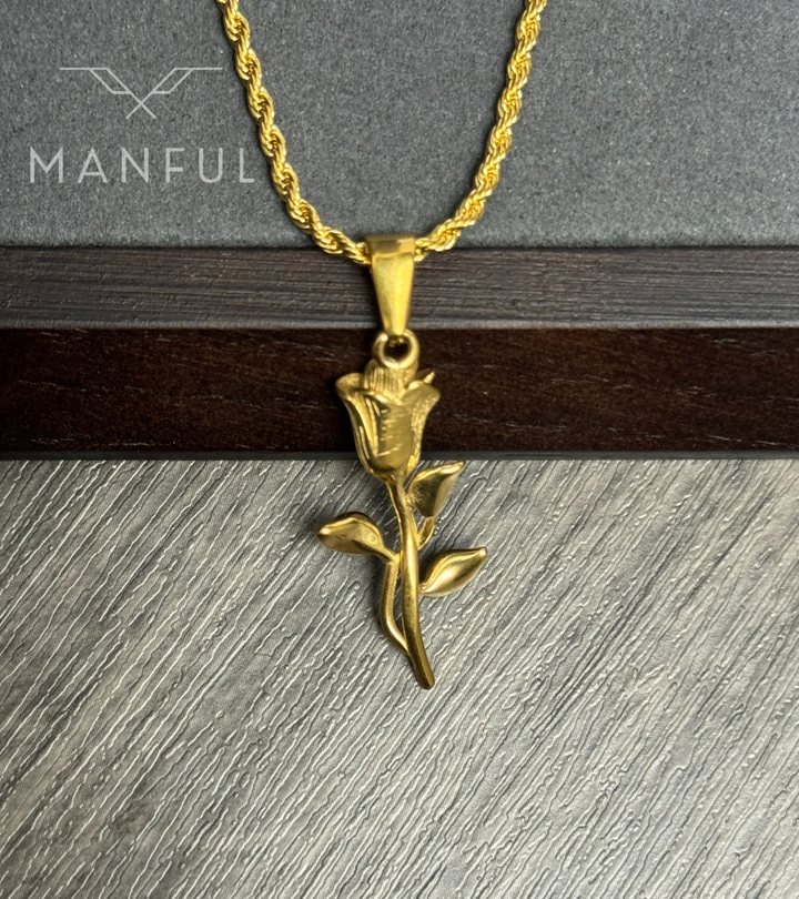 Rose Pendant Necklace Gold, hanging against a dark wood beam and grey wood backdrop