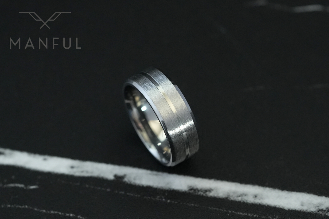 Silver Band, angled on a black marble surface with a thin white vein running through
