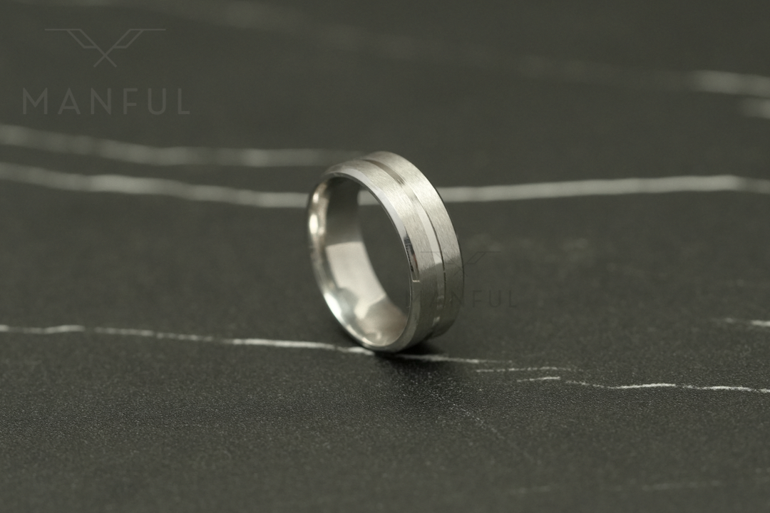 Silver Band, standing upright on a dark marble surface facing the camera