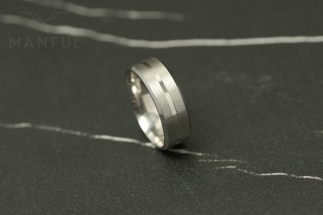 Silver Band, lying on its side on a dark marble surface in profile
