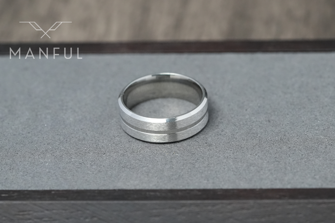 Silver Band, standing upright on a grey stone-textured surface