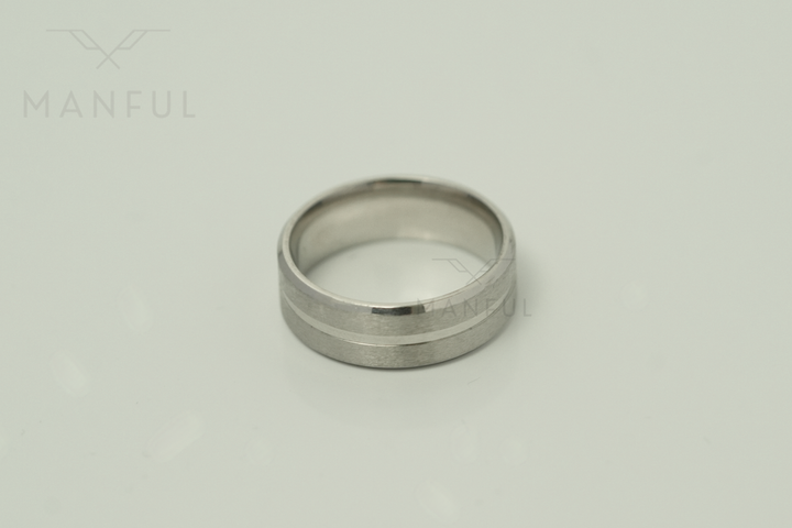 Silver Band, lying flat viewed from above on a pale grey background