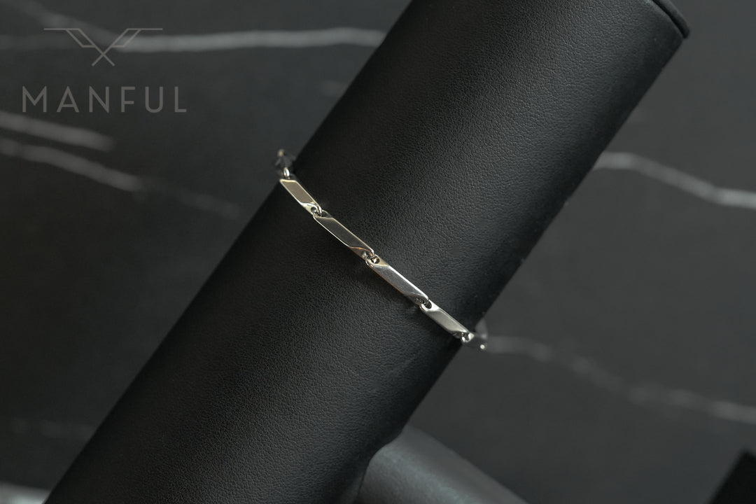 Block Chain Bracelet Silver, draped over a black leather stand showing the elongated bar links