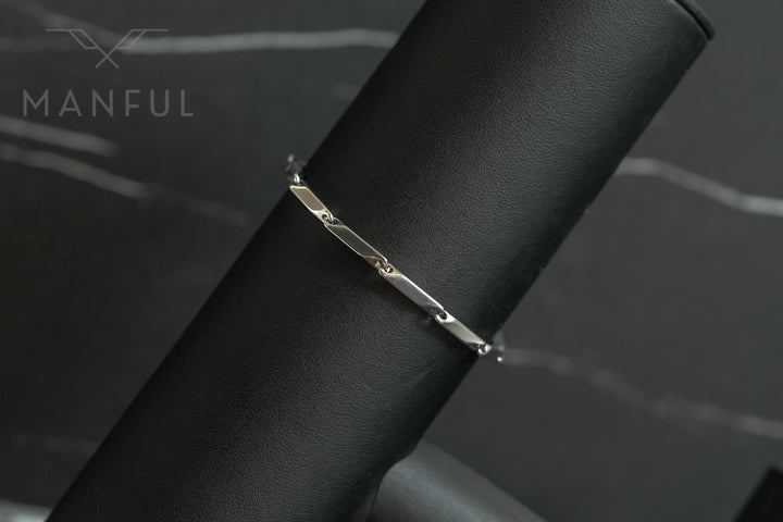 Block Chain Bracelet Silver, draped over a black leather stand showing the elongated bar links