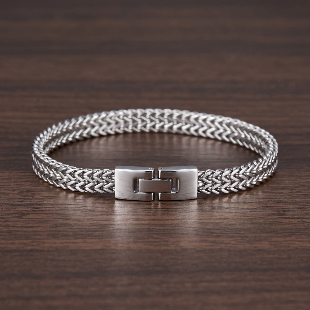 Foxtail Bracelet (Silver) lying on a walnut table