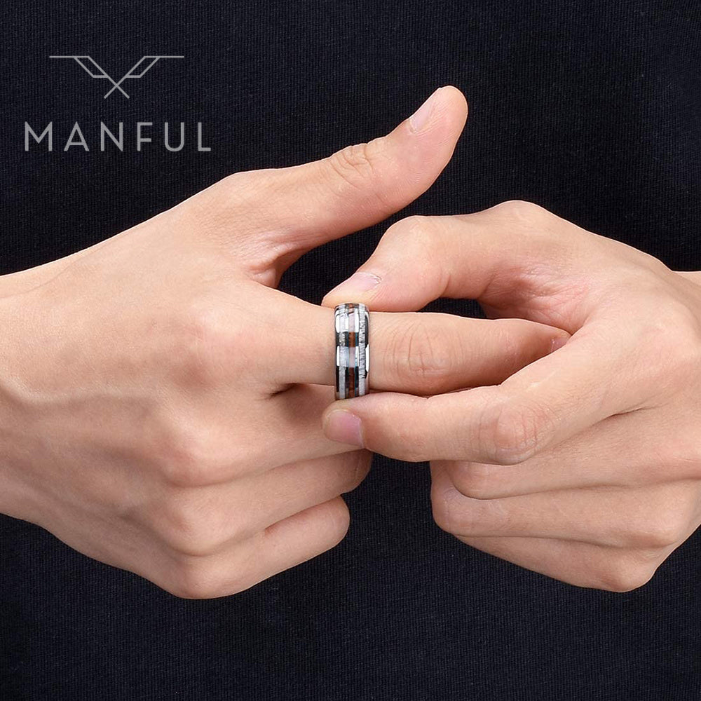 Silver Woodland Band, worn on a man's finger against dark clothing