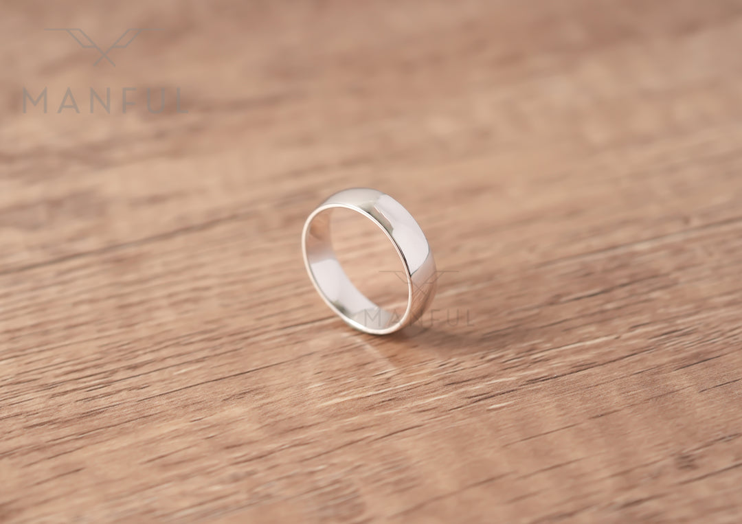 Simple 6mm 925 Silver Ring, standing upright on a wood surface