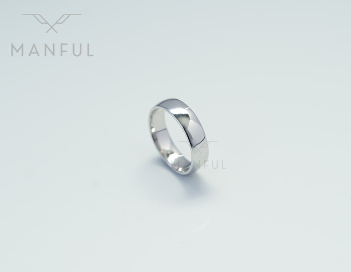 Simple 6mm 925 Silver Ring, standing upright on a pale grey background
