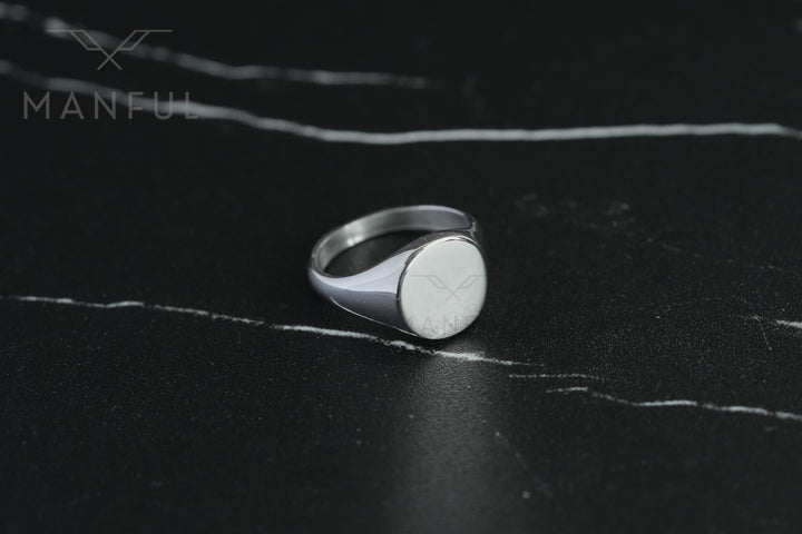 Classic Silver Signet Ring, front-facing on a dark marble surface