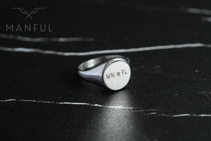 Classic Silver Signet Ring, close-up on dark slate showing initials and a heart engraved on the face
