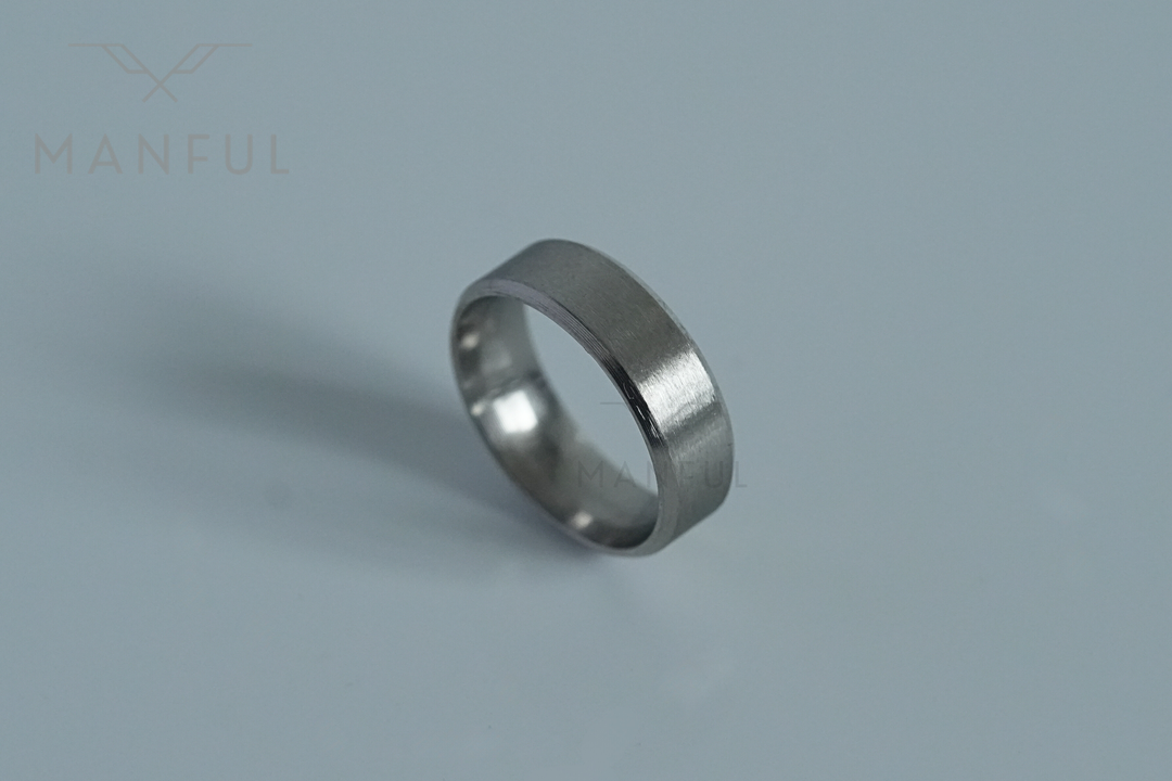 Simple Stainless Steel Ring 8mm Silver, angled on a plain pale grey background