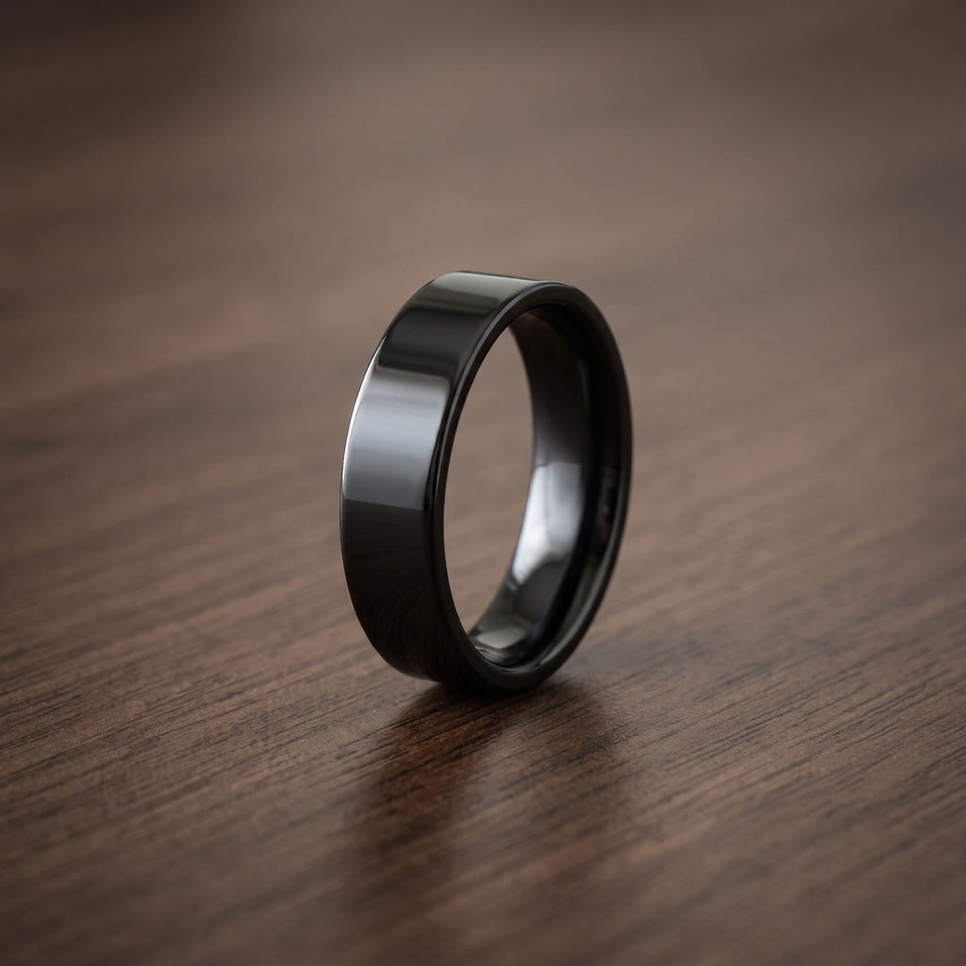 Simple 6mm Ring (Black) standing on a dark walnut table