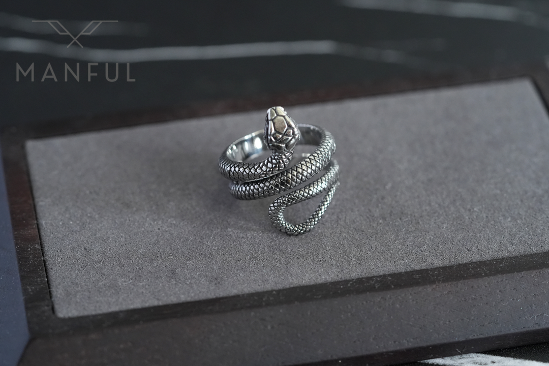 Snake Ring, resting on a flat grey foam display tray