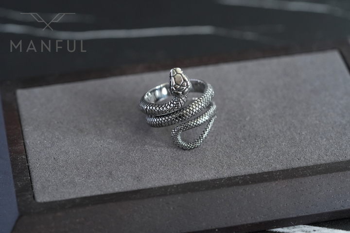 Snake Ring, resting on a flat grey foam display tray