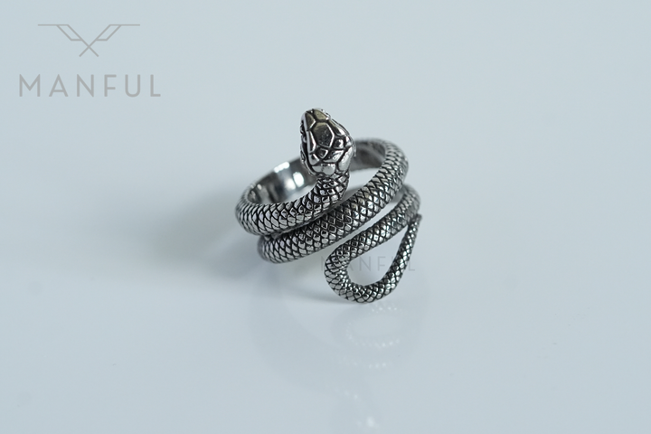 Snake Ring, angled side view on a white background with a soft reflection beneath