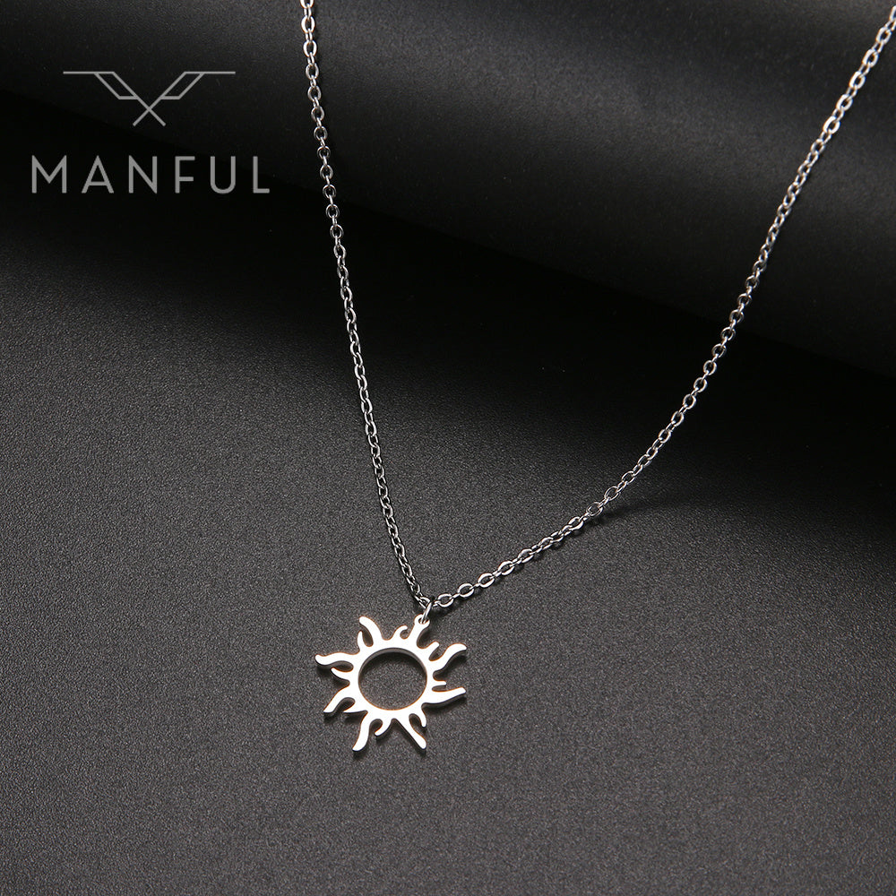 Sun Pendant Necklace Silver, hanging against a dark textured background