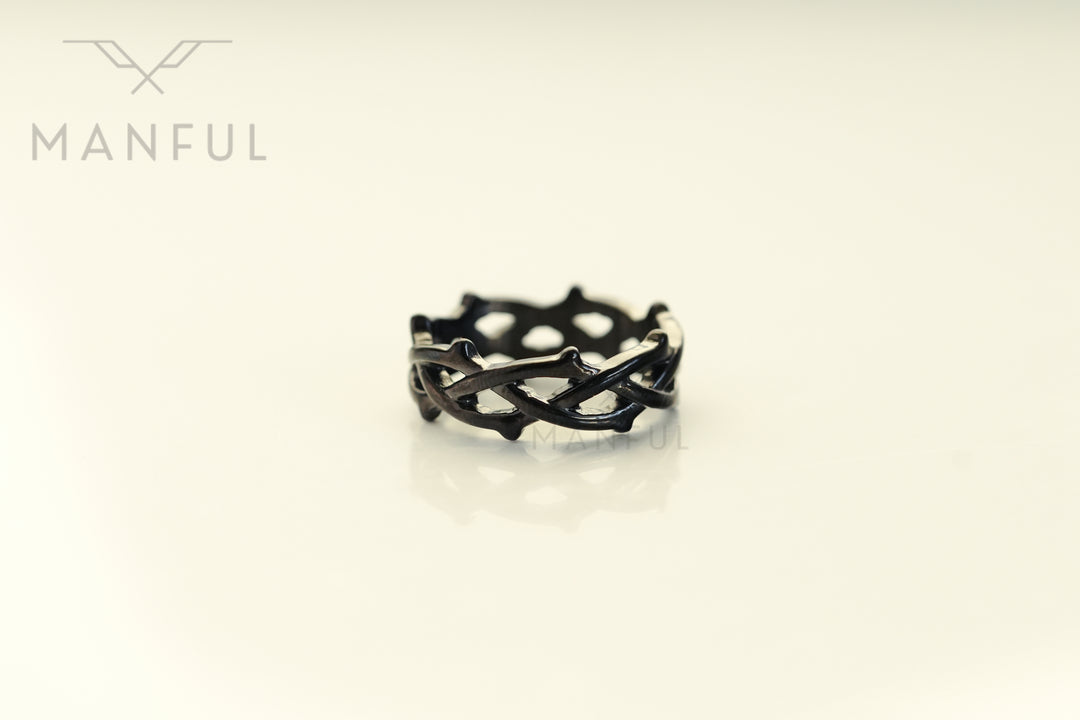 Thorn Ring Black, isolated on a cream background face-on showing the thorn spikes around the band