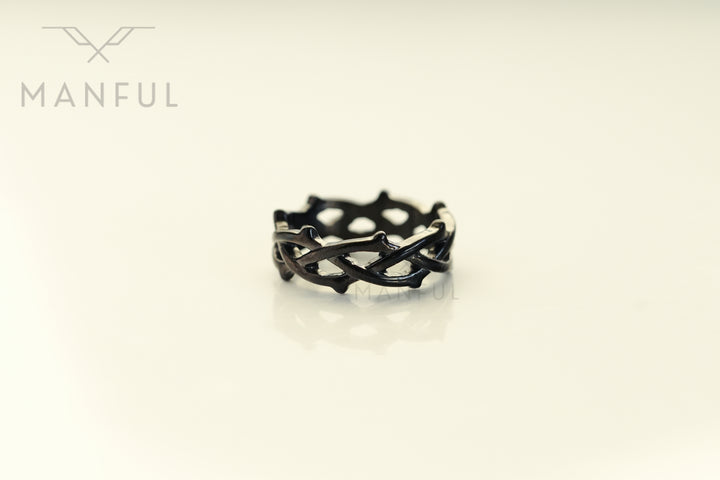 Thorn Ring Black, isolated on a cream background face-on showing the thorn spikes around the band