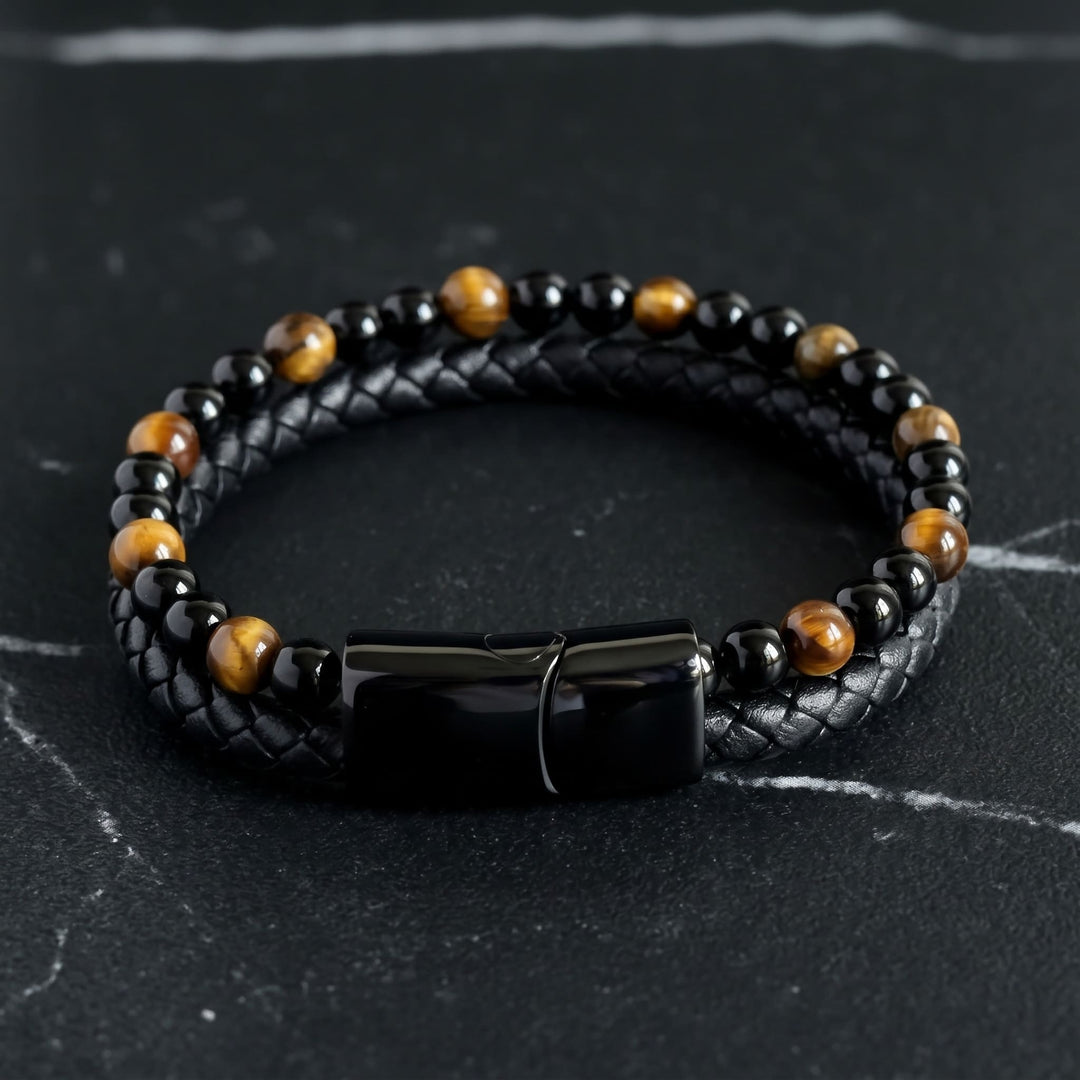 Tigers Eye Bead And Leather Bracelet lying on black marble with thin white veins