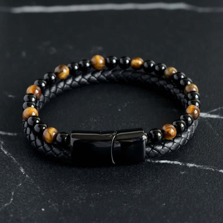 Tigers Eye Bead And Leather Bracelet lying on black marble with thin white veins