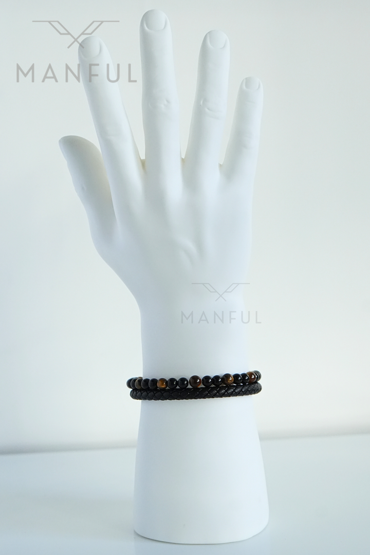 Tigers Eye Bead And Leather Bracelet, worn on a mannequin wrist with fingers spread open