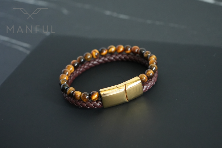 Tigers Eye Bead And Leather Bracelet Gold, close flat lay on dark marble showing the engraved gold clasp