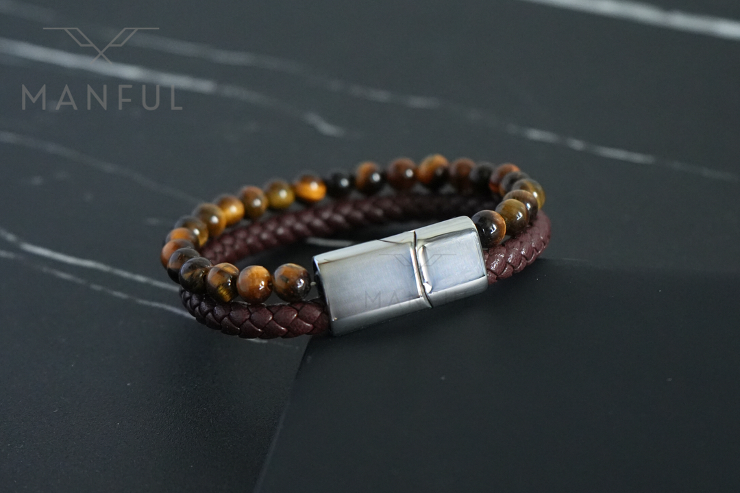 Tigers Eye Bead And Leather Bracelet Silver, laid flat on dark slate with light marbled veining behind it